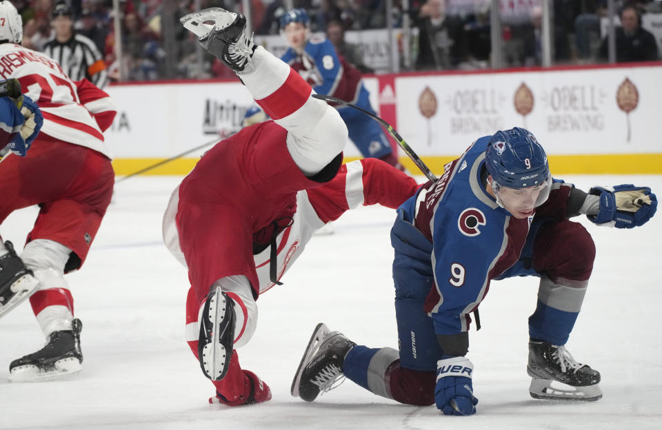 Colorado Avalanche center Evan Rodrigues, right, flips Detroit Red Wings defenseman Olli Maatta in the third period of an NHL hockey game Monday, Jan. 16, 2023, in Denver. (AP Photo/David Zalubowski)