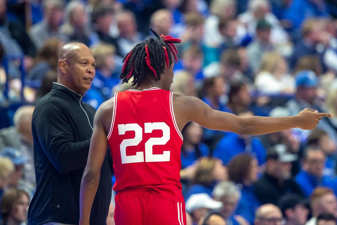 Louisville head coach Kenny Payne talks with forward Kamari Lands during their team’s game against Kentucky at Rupp Arena on Dec. 31, 2022.