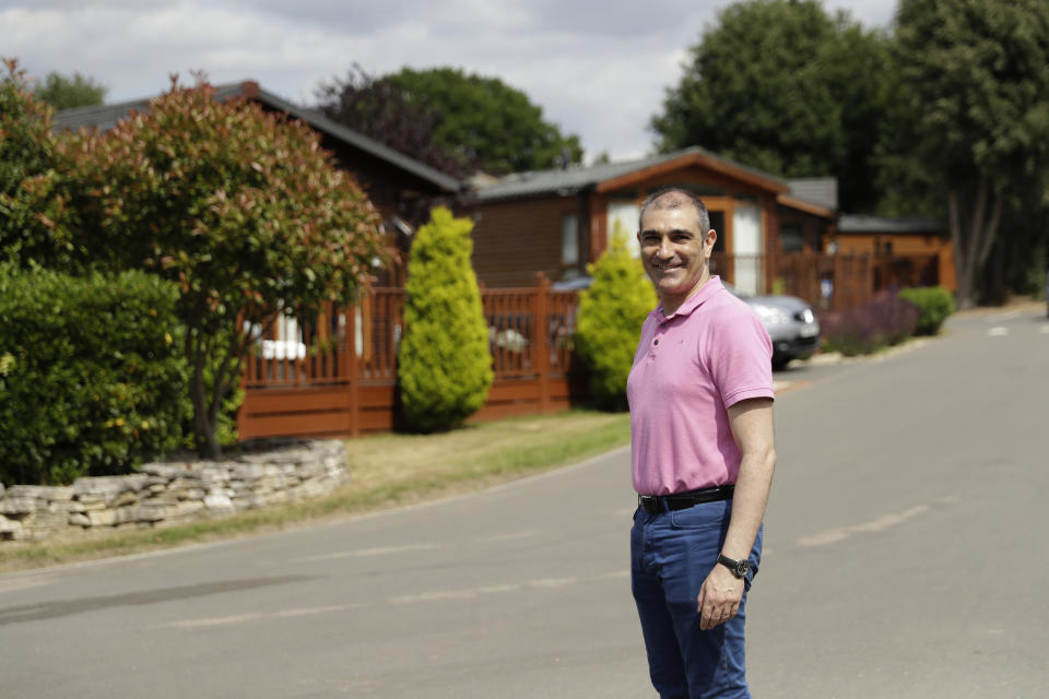 General manager Philip Pantelis poses for photographs at the Edgeley Holiday Park in Farley Green, near Guildford, south west of London, Wednesday, July 22, 2020. With all schools now closed, Friday would normally be the busiest departure day of the year for London’s Gatwick Airport with families heading off to the sun-soaked beaches in southern Europe. Not this year as the coronavirus pandemic has meant many have opted against making their annual summer migration to countries like Spain and Greece. Gatwick would in any normal year be expecting to fly some 85,000 holidaymakers on Friday alone. It expects less than 10,000 passenger departures on Friday. (AP Photo/Matt Dunham)