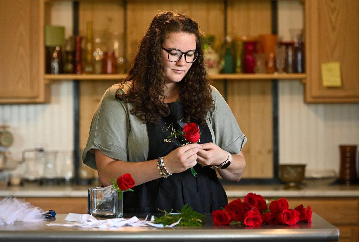 Sara Smith prepares roses at Mrs. B’s Floral and Nursery in downtown Lincoln. Smith and her husband, Radney, moved from Salt Lake City in February, wanting to raise their 9-month-old baby in a small town. 