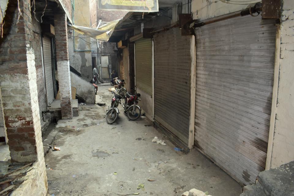 Local residents chat on the edge of a narrow alley of Machli Bazar area, where Britain's new prime minister Rishi Sunak's paternal grandfather Ramdas Sunak reportedly lived, in Gujranwala, Pakistan, Wednesday, Oct. 26, 2022. Britain's new prime minister, Rishi Sunak, has embraced his Indian and Hindu heritage but he also has roots in present-day Pakistan, in the industrial city of Gujranwala in the country's eastern Punjab province, where his paternal grandfather reportedly lived until 1935 during Britain's colonial rule. (AP Photo/Aftab Rizvi)