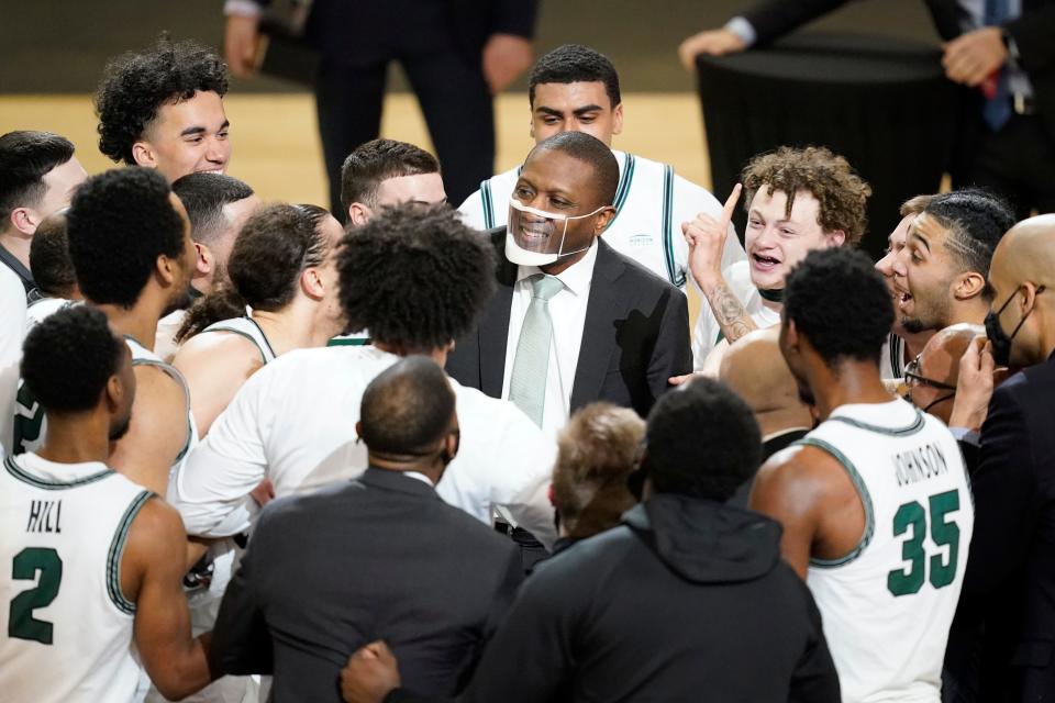 Cleveland State head coach Dennis Gates celebrates with his team following the Horizon League Tournament championship game against Oakland on March 9, 2021, in Indianapolis. Cleveland State won 80-69.