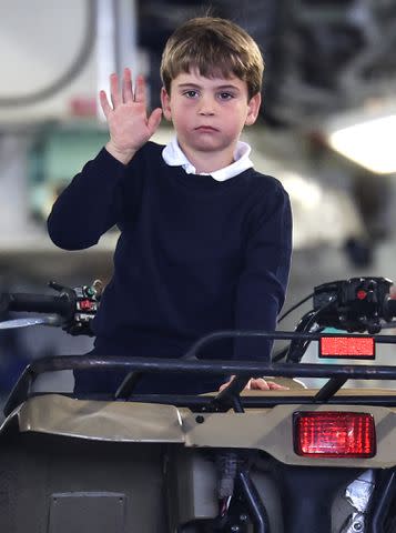 <p>Chris Jackson/Getty Images</p> Prince Louis of Wales waves as he sits inside a vehicle on a C17 plane during a visit to the Air Tattoo at RAF Fairford.
