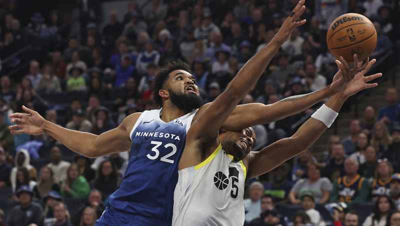 Minnesota Timberwolves center Karl-Anthony Towns (32) fights for the ball against Utah Jazz guard Talen Horton-Tucker (5) during the second half of an NBA basketball game Saturday, Nov. 4, 2023, in Minneapolis. (AP Photo/Stacy Bengs)