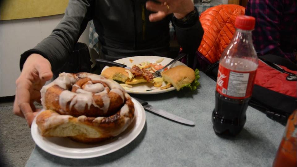 What a feast: Racer Gareth Hardcastle reaches for one of Braeburn Lodge's famous cinnamon buns which are as large as a dinner plate. 