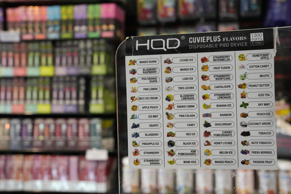 A list of flavors of disposable electronic cigarette devices made by the Chinese brand HQD is displayed at Vapes N Smoke in Pinecrest, Fla., Monday, June 26, 2023. Since 2020, the number of different e-cigarette devices for sale in the U.S. has exploded to more than 9,000, a nearly three-fold increase driven almost entirely by a wave of disposable vapes from China. (AP Photo/Rebecca Blackwell)