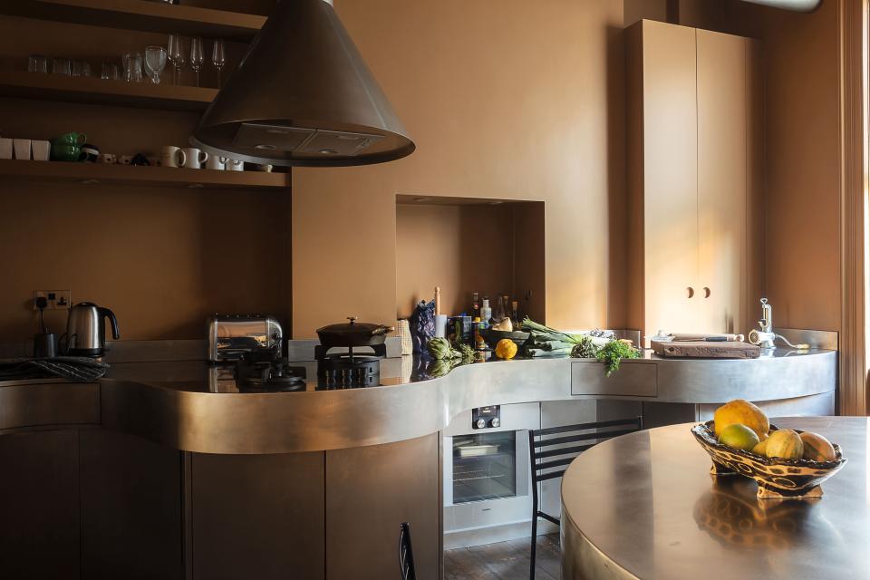 The bespoke stainless-steel kitchen was made by Stuart Indge; barstools by Giandomenico Belotti.