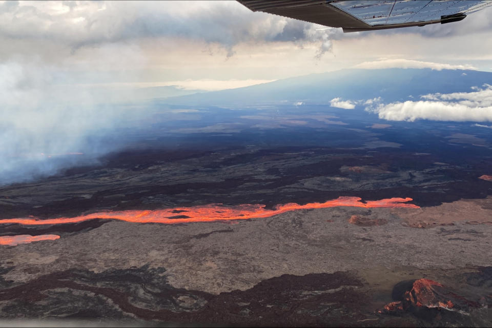 In this aerial photo released by the U.S. Geological Survey, the Mauna Loa volcano is seen erupting from vents on the Northeast Rift Zone on the Big Island of Hawaii, Monday, Nov. 28, 2022. Hawaii's Mauna Loa, the world's largest active volcano, began spewing ash and debris from its summit, prompting civil defense officials to warn residents on Monday to prepare in case the eruption causes lava to flow toward communities. (U.S. Geological Survey via AP)