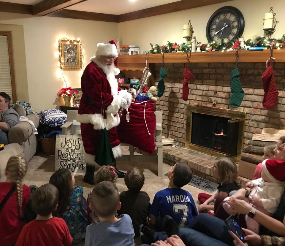 Santa's Helper Frank Kohring of Canton Township with his 34 grandchildren during a family Christmas gathering