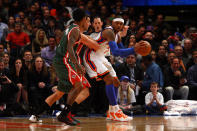 Carmelo Anthony (right) looks to pass in the post in the first half against Carlos Delfino and Brandon Jennings (foreground) of the Milwaukee Bucks at Madison Square Garden on March 26, 2012 in New York. (Photo by Chris Chambers/Getty Images)