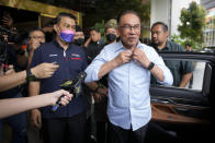 Malaysian opposition leader Anwar Ibrahim, foreground, arrives at a hotel to meet the leaders of United Malays National Organization in Kuala Lumpur, Malaysia, Monday, Nov. 21, 2022. Malaysia's king on Thursday, Nov. 24, 2022, named Anwar as the country's prime minister, ending days of uncertainties after divisive general elections produced a hung Parliament. (AP Photo/Vincent Thian)