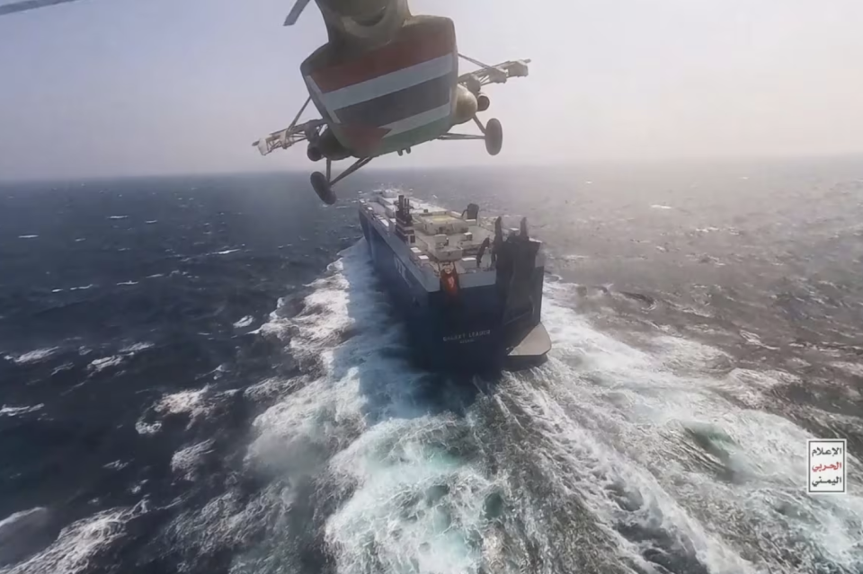 This photo released by the Houthi Media Center shows a Houthi forces helicopter approaching the cargo ship Galaxy Leader in November. Conflict in the area has caused shipping delays and cost increases for some companies. (Houthi Media Center/The Associated Press)