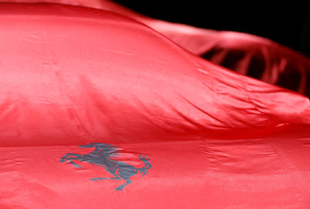 FILE PHOTO: The logo of Ferrari is seen on a sheet covering a car before a presentation at the 88th International Motor Show at Palexpo in Geneva, Switzerland, March 6, 2018. REUTERS/Pierre Albouy/File Photo