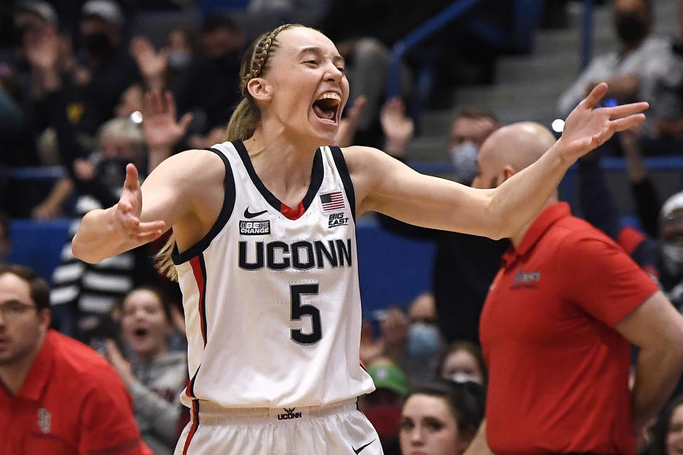 Connecticut's Paige Bueckers reacts after making her first basket after coming back from being injured, in the first half of an NCAA college basketball game against St. John's, Friday, Feb. 25, 2022, in Hartford, Conn. (AP Photo/Jessica Hill)