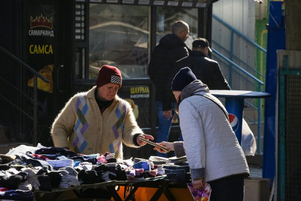 Local residents shop at the main market in the city of Mykolaiv on 10 November 2022 (AFP via Getty Images)