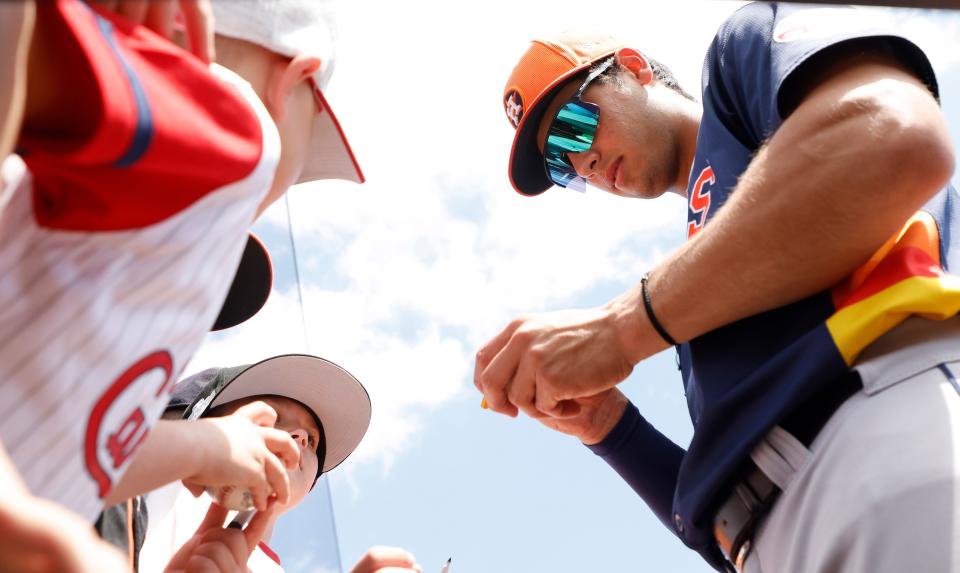 Astros shortstop Shay Whitcomb signs autographs before a spring training game against the St. Louis Cardinals at Roger Dean Chevrolet Stadium.