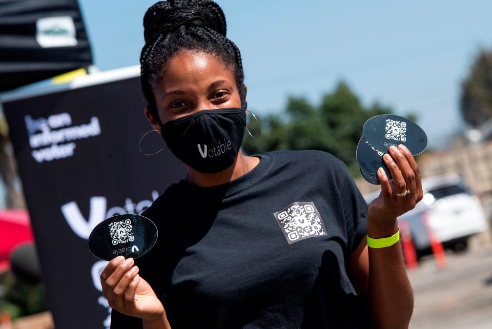 A volunteer shows the bar code that she gives to people to register to vote online at the Gen-Z Drive Up Voter Registration Event organized by BeWoke Vote, September 19, 2020, in Compton, California.