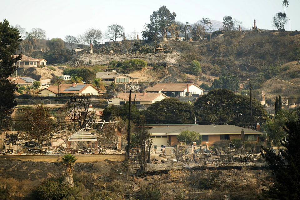 FILE - In this Dec. 6, 2017, file photo, homes scorched by a wildfire line a hillside in Ventura, Calif. California's massive property insurance market is feeling the effects of three straight years of damaging wildfires. Insurers have pulled out of some markets and canceled thousands of policies, forcing regulators to step in and expand a state program that homeowners often turn to as a last resort. (AP Photo/Noah Berger, File)