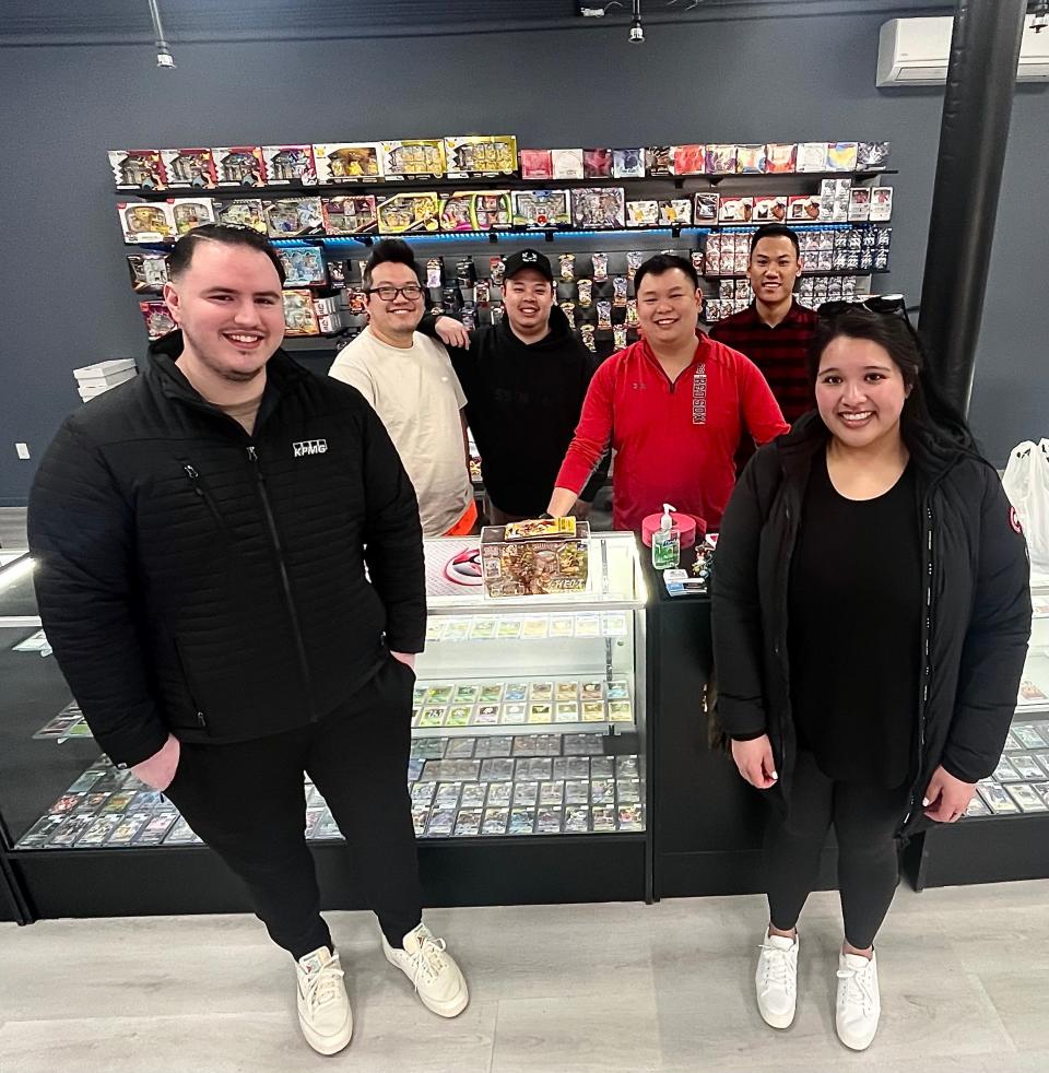 Customers Jeff Chetwynd, far left, and his girlfriend Cindy Garcia are seen here with the four owners of a new Pokemon and sports card business called Dream Collectors at 16 Taunton Green on Saturday, Feb. 24, 2024.