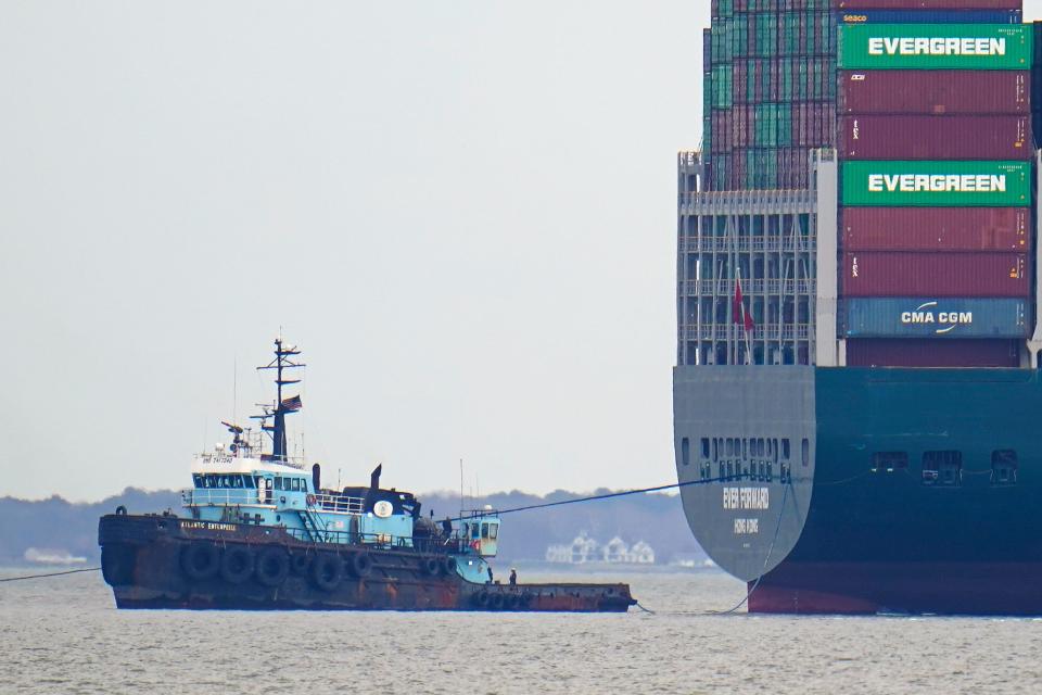 The tugboat Atlantic Enterprise, left, pulls the container ship Ever Forward, which ran aground, as crews continued for a second day to attempt to refloat the ship, Wednesday, March 30, 2022.