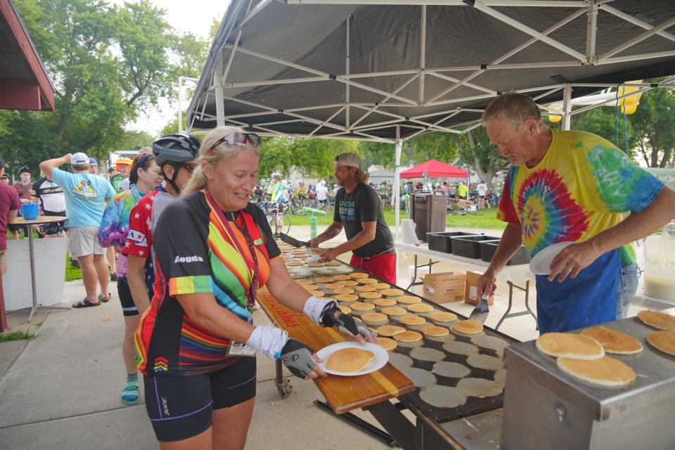 Tim Cook serves pancakes at Chris Cakes in Sioux City on RAGBRAI 50.