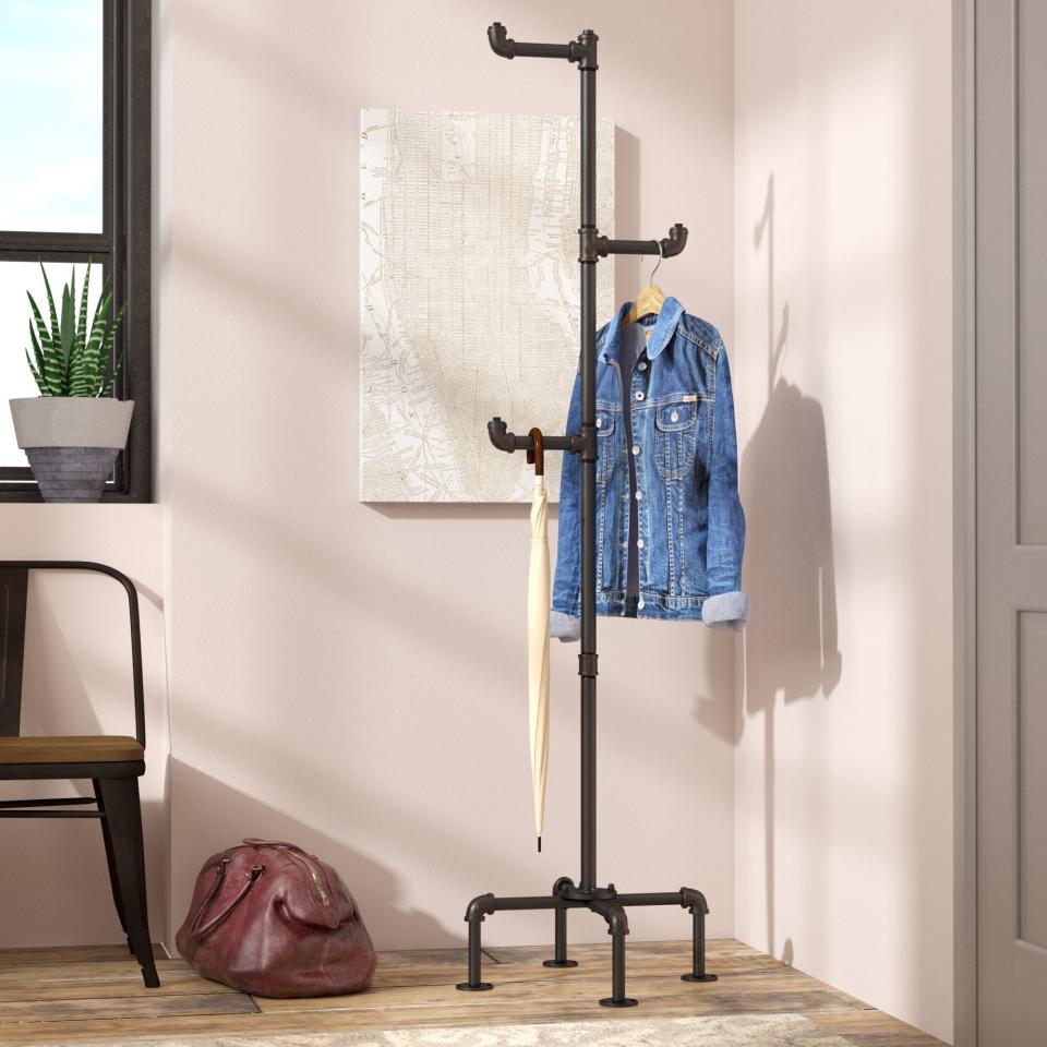 the black coat rack with three hooks