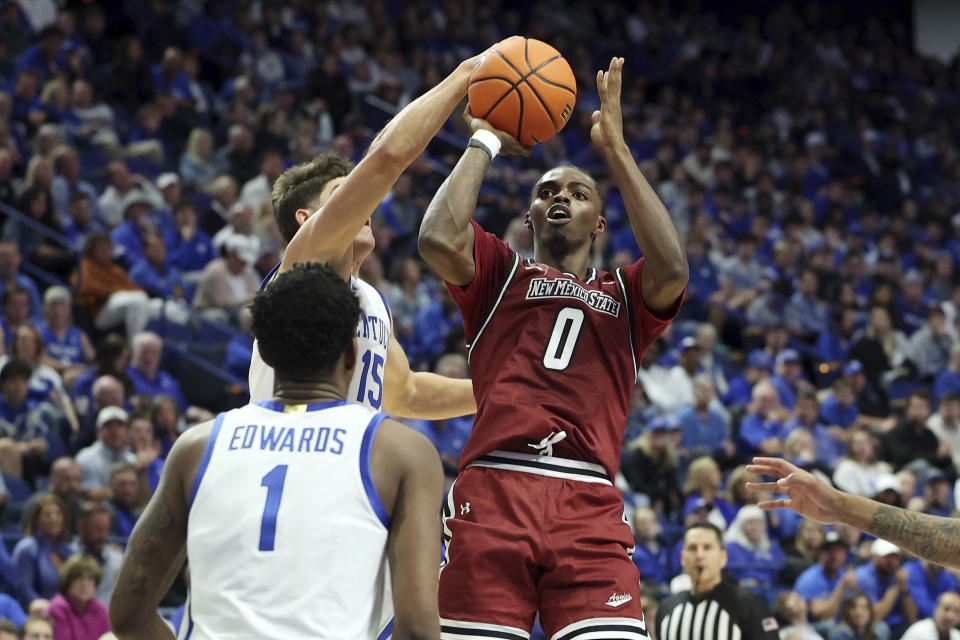 New Mexico State's Jaylin Jackson-Posey (0) has his shot blocked by Kentucky's Reed Sheppard, top left, during the second half of an NCAA college basketball game in Lexington, Ky., Monday, Nov. 6, 2023. (AP Photo/James Crisp)