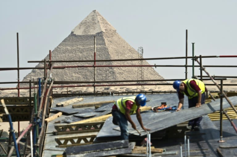 Construction workers are seen at the site of the new Grand Egyptian Museum near the Giza pyramids in Cairo on June 4, 2015