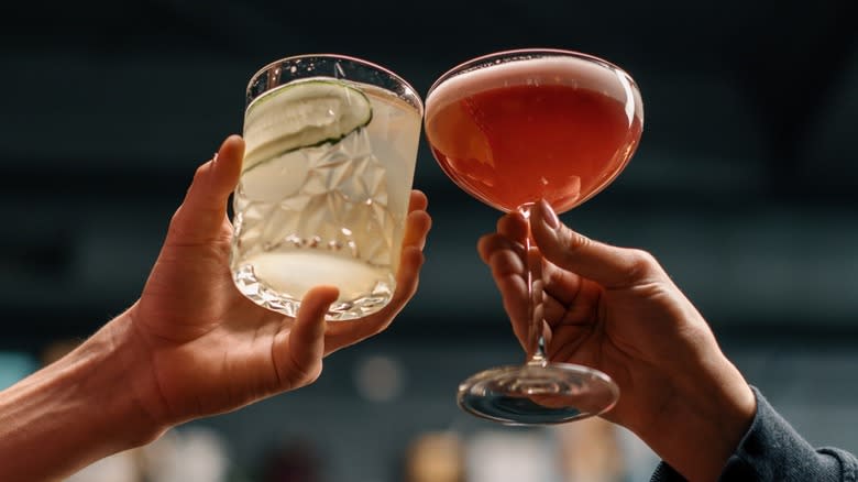 Hands cheering two cocktails