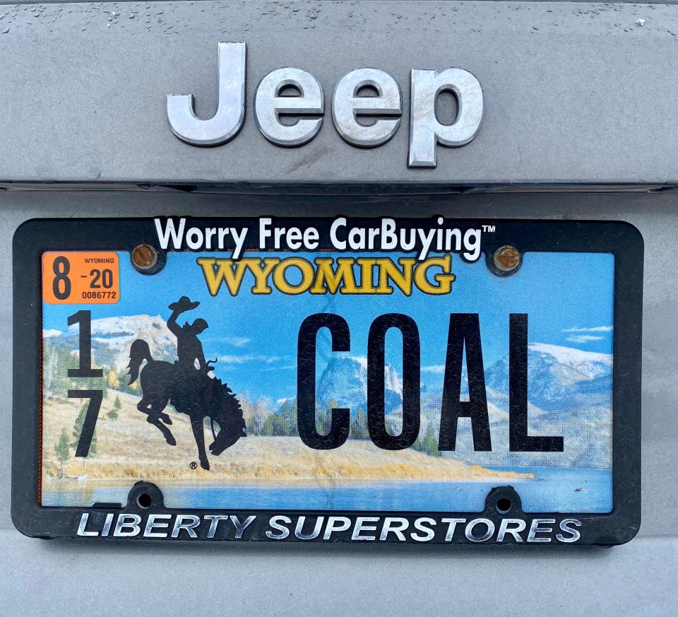The license plate on a Wyoming resident's car pays homage to his father's long career as a coal miner in one of the mines surrounding Gillette, Wyoming. But the coal mines in this area are expected to see reduced demand as additional sources of renewable energy replace the burning of fossil fuels.