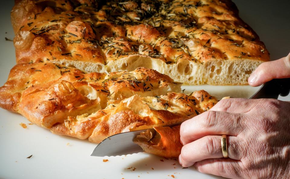 Chef-owner Adam Siegel slices focaccia for the bread baskets at Lupi and Iris restaurant downtown.