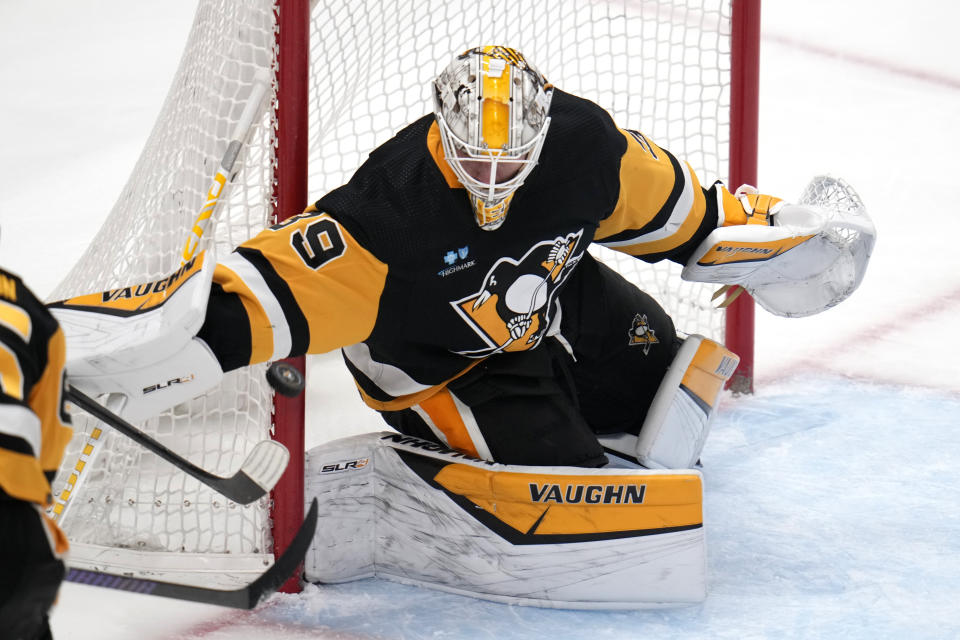 Pittsburgh Penguins goaltender Alex Nedeljkovic blocks a Carolina Hurricanes shot during the first period of an NHL hockey game in Pittsburgh, Tuesday, March 26, 2024. (AP Photo/Gene J. Puskar)