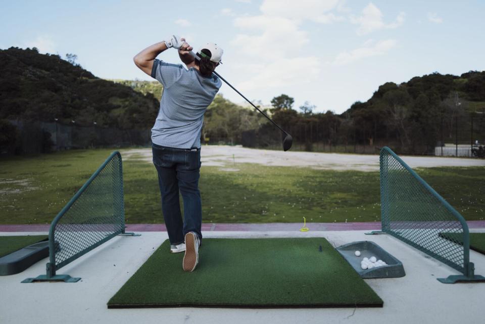 Dave Fink drives a ball at the Wilson Harding Driving Range.