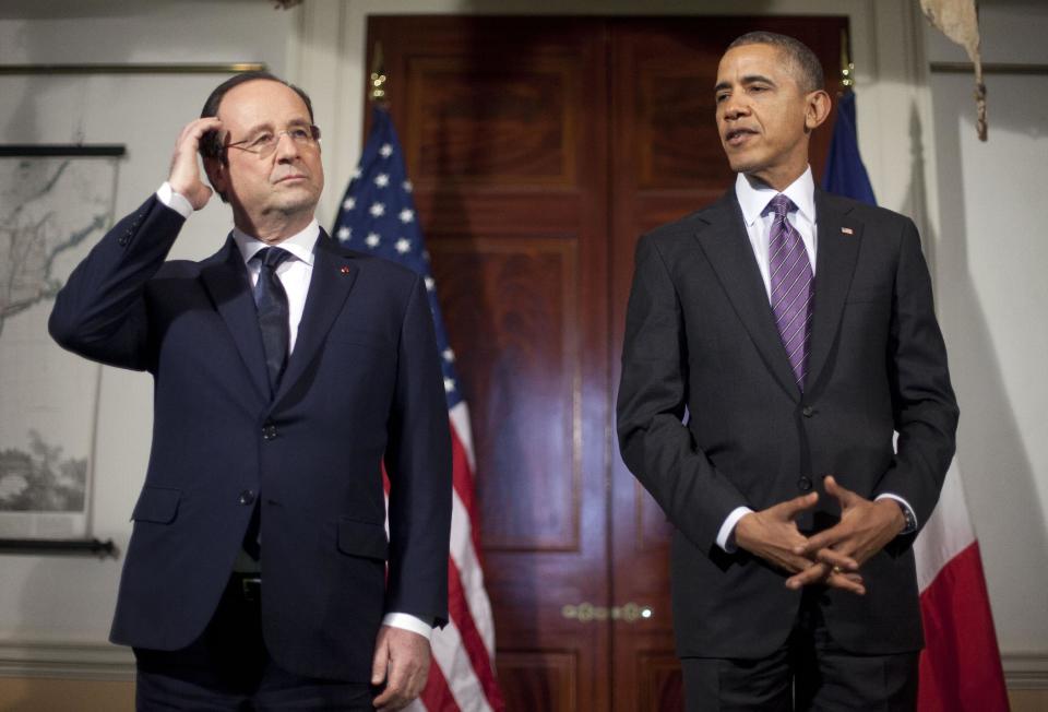 President Barack Obama, right, and French President Francois Hollande, left, pause as they talk to members of the media following their tour of Monticello, President Thomas Jefferson’s estate, Monday, Feb. 10, 2014, in Charlottesville, Va. (AP Photo/Pablo Martinez Monsivais)