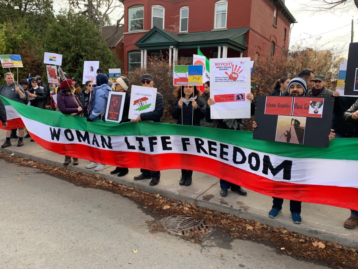 About 200 people took part in a rally against the Russian and Iranian governments outside the Russian Embassy in Ottawa on Saturday. (Guy Quenneville/CBC - image credit)