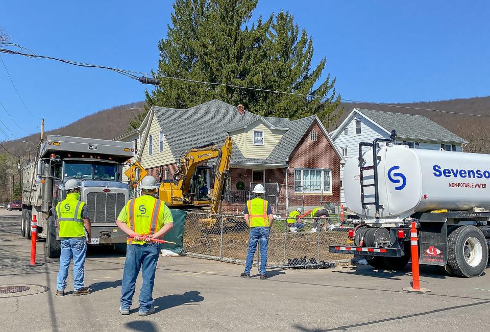 A cleanup team works to remediate a property on East Pulteney Street in 2021. The work in Corning, which is continuing this year, is geared to eliminate potential exposure to contaminants including arsenic, cadmium, lead and semi-volatile organic compounds.