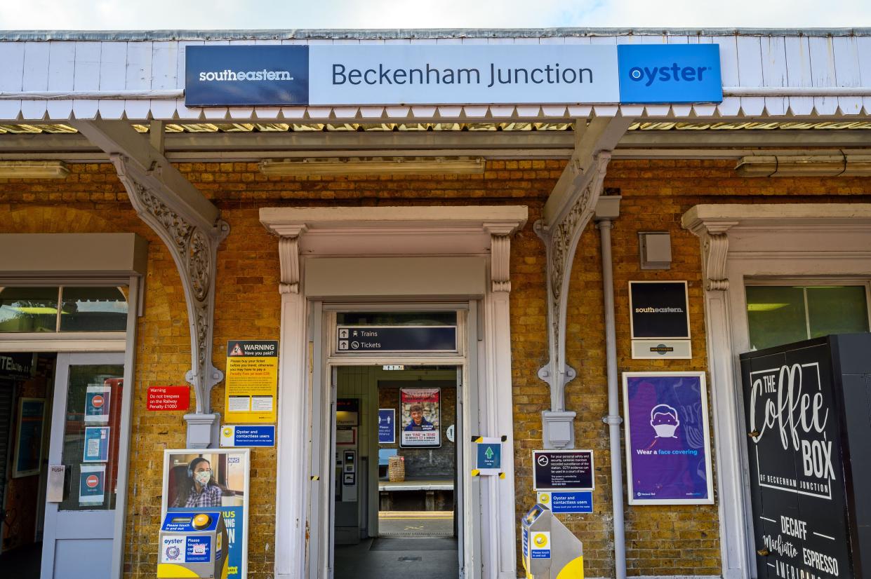 Beckenham (Greater London), Kent, UK. Entrance to Beckenham Junction railway station with station sign and card readers looking through to platform.