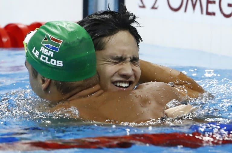 Singapore&#39;s Joseph Schooling (R) celebrates with South Africa&#39;s Chad le Clos after in the 100m butterfly in Rio