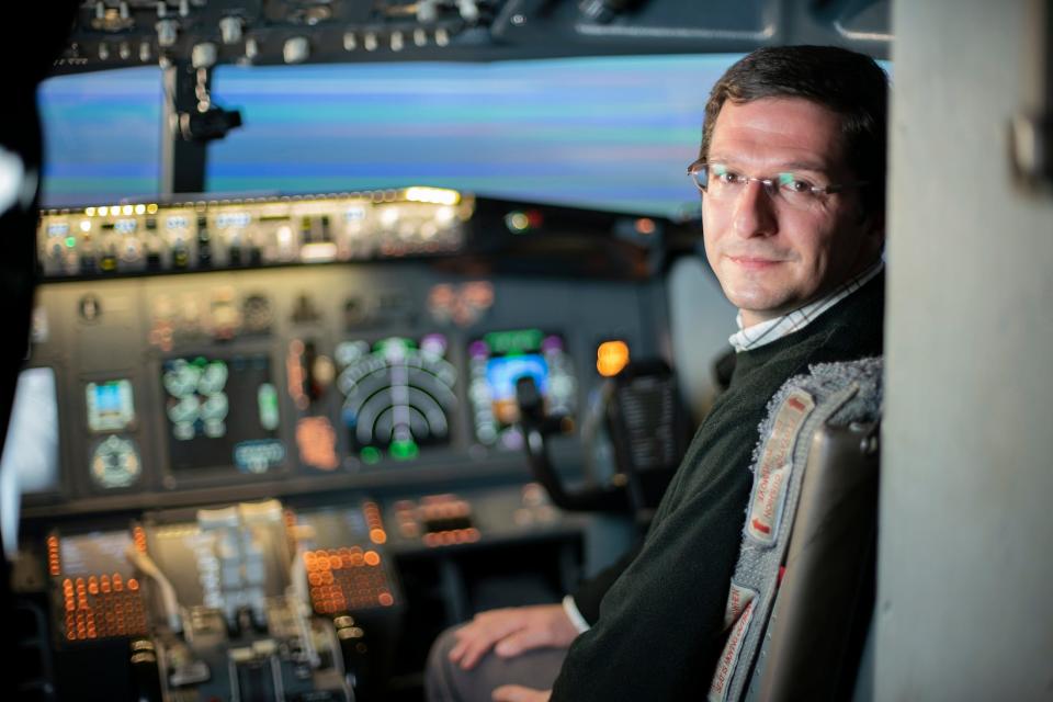 paul williams sitting in the cockpit of a commercial plane