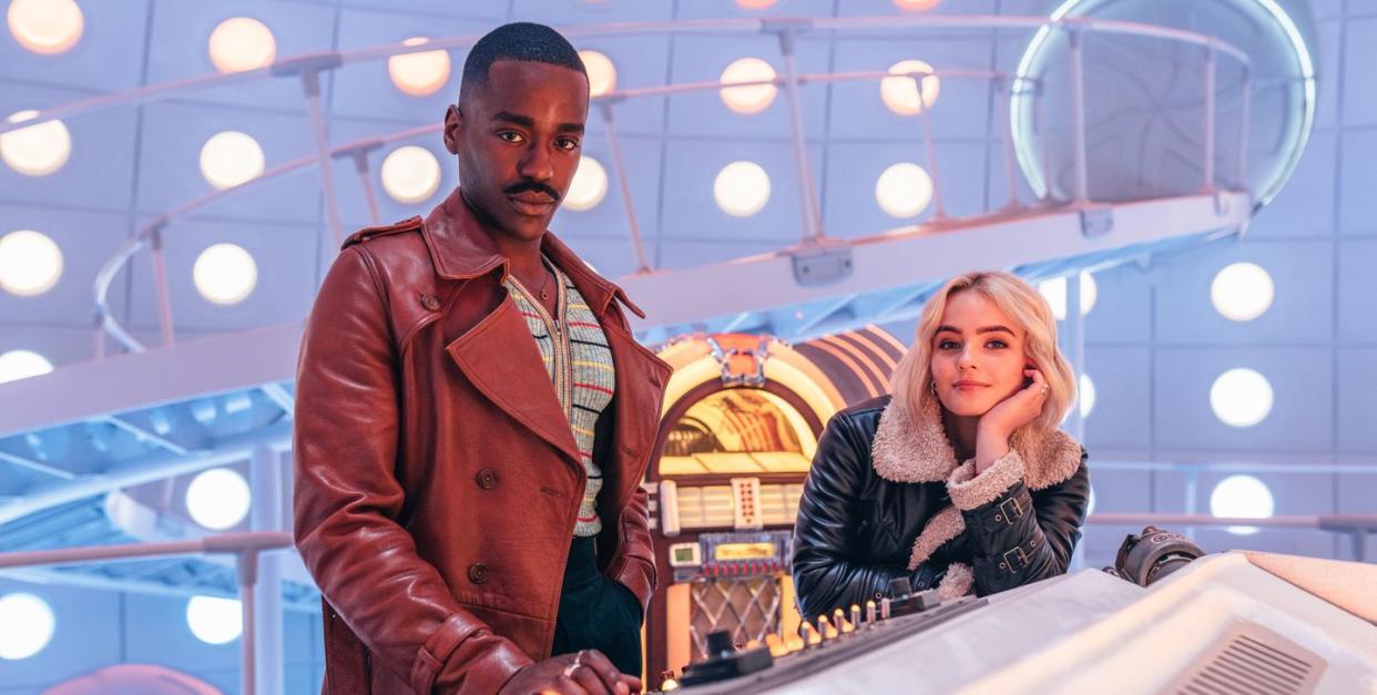 doctor who stars ncuti gatwa and millie gibson in the tardis, with the doctor's diner style jukebox in the background behind them