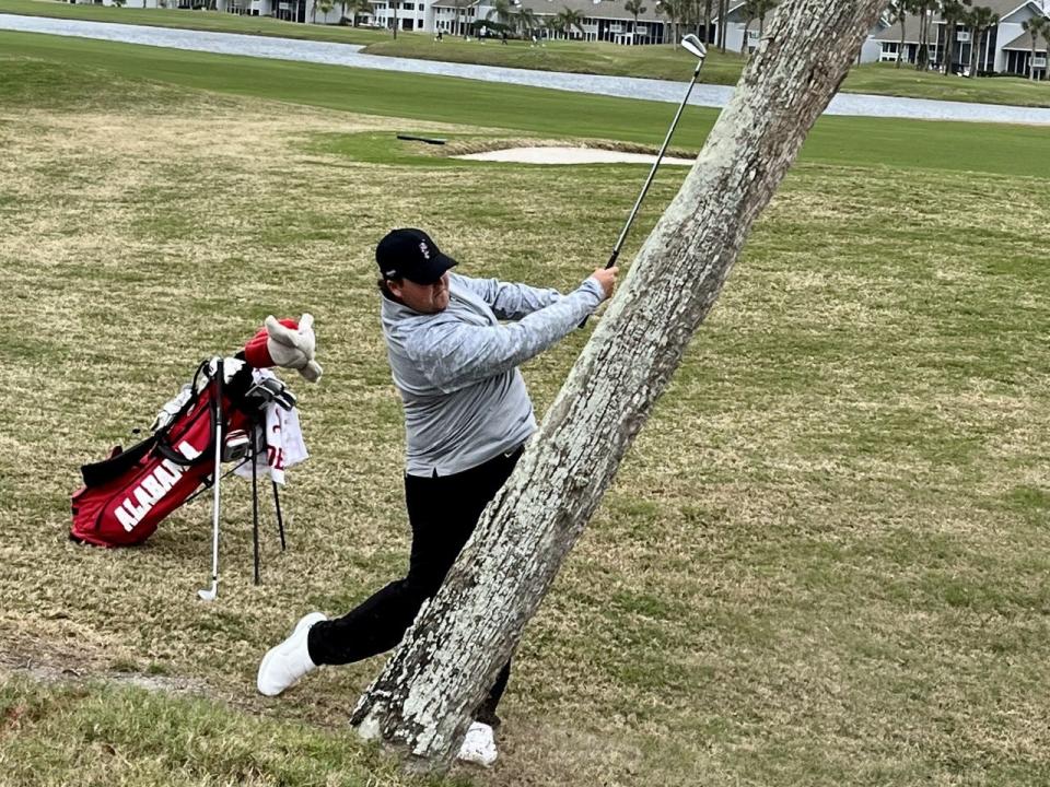 Alabama's Canon Claycomb hits from near a tree off the 18th fairway of the Sawgrass Country Club on Sunday during the first round of The Hayt.