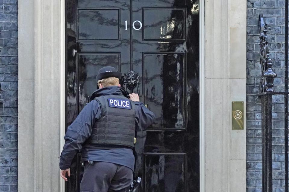 A police officer knocks on the door of the Prime Minister’s official residence (Stefan Rousseau/PA) (PA Wire)