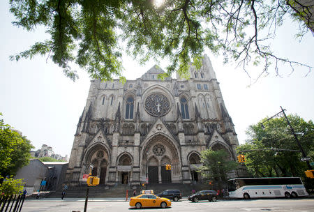 FILE PHOTO: People drive past the Cathedral of St. John the Divine in New York, June 25, 2013. Actor James Gandolfini's funeral will be held in the Cathedral this Thursday. REUTERS/Carlo Allegri/File Photo