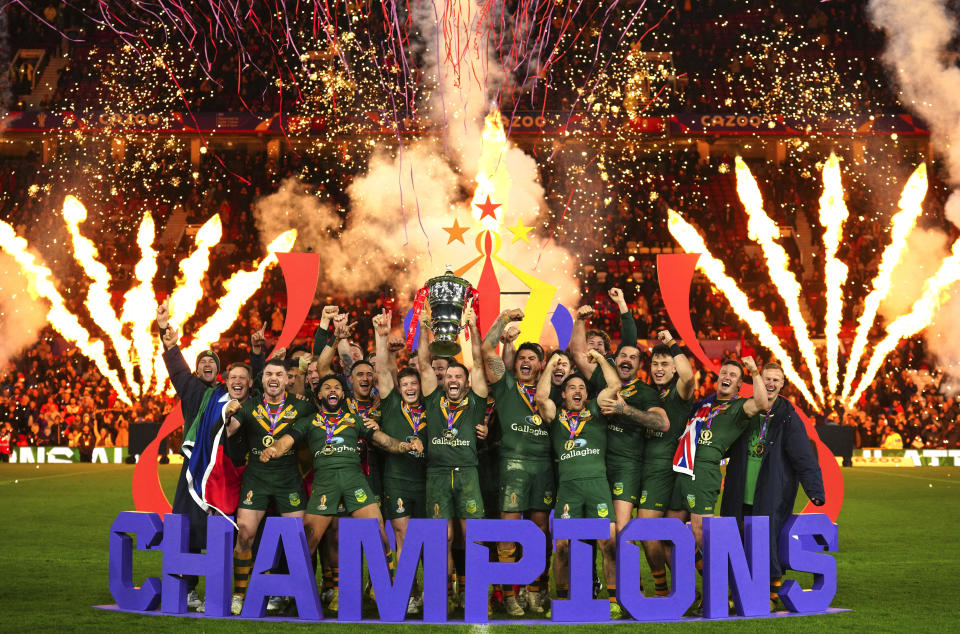 Australia's players celebrate with the trophy after winning during the Rugby League World Cup final match between Australia and Samoa at the Old Trafford Stadium in Manchester, England, Saturday, Nov. 19, 2022. (AP Photo/Jon Super)