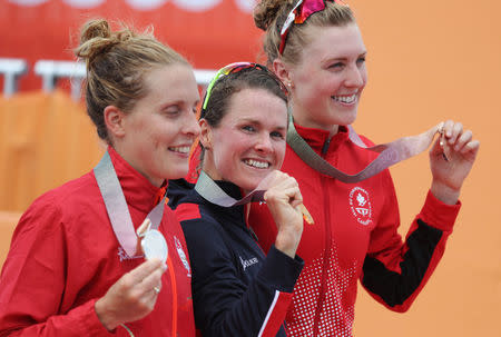 Triathlon - Gold Coast 2018 Commonwealth Games - Women's Final - Southport Broadwater Parklands - Gold Coast, Australia - April 5, 2018 - Gold medallist Flora Duffy of Bermuda, silver medallist Jessica Learmonth of England and bronze medallist Joanna Brown of Canada. REUTERS/Athit Perawongmetha