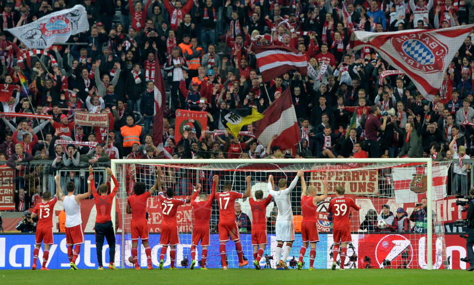 Bayern's players celebrate with supporters after the Champions League quarterfinal second leg soccer match between Bayern Munich and Manchester United in the Allianz Arena in Munich, Germany, Wednesday, April 9, 2014. Munich defeated Manchester by 3-1. (AP Photo/Kerstin Joensson)