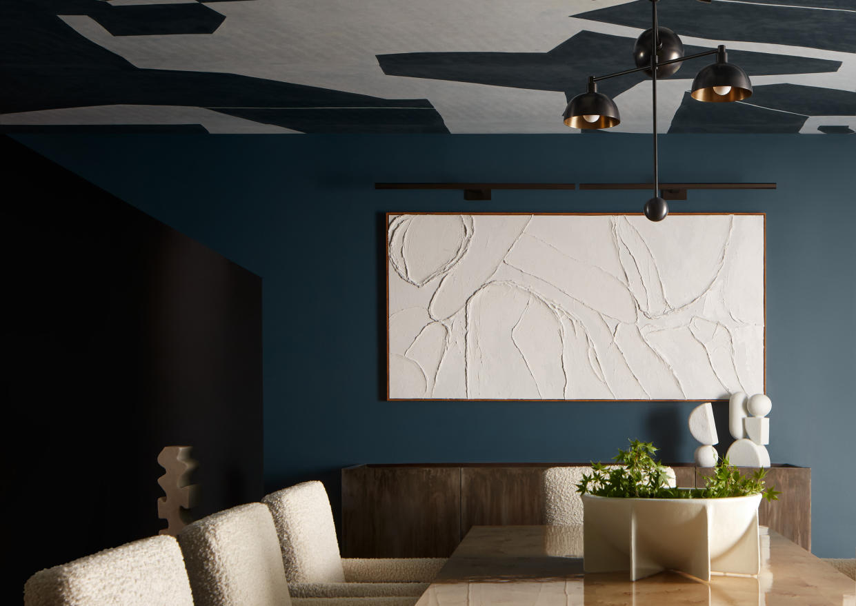  Blue dining room with black and white wallpaper on the ceiling. 