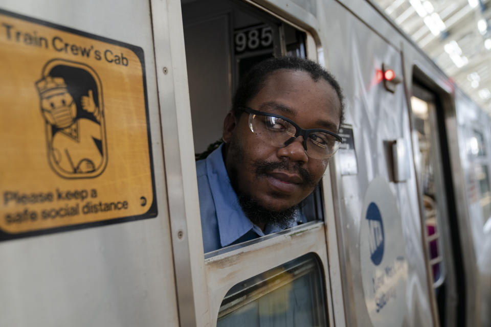 Desmond Hill, a vaccinated MTA conductor, checks the platform for late riders attempting to board the train as he works the N subway line from Brooklyn's Coney Island to Queen's Astoria-Ditmars neighborhoods, Friday, Aug. 13, 2021, in New York. As New York City recovers from the COVID-19 pandemics' peak ridership on the aging transit system continues to rebound as authorities encourage mask and social distancing protocols to stem further transmission of the virus. (AP Photo/John Minchillo)