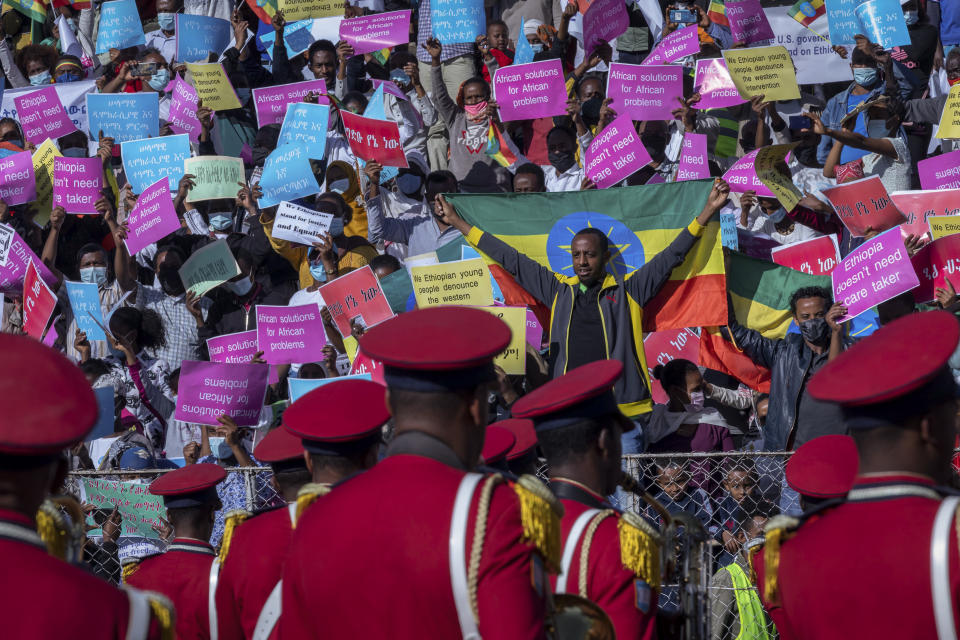 Ethiopians protest against international pressure on the government over the conflict in Tigray, at a demonstration organised by the city mayor's office held at a stadium in the capital Addis Ababa, Ethiopia Sunday, May 30, 2021. Thousands of Ethiopians gathered Sunday to protest outside pressure on the government over its brutal war in Tigray, after the U.S. said last week it has started restricting visas for government and military officials of Ethiopia and Eritrea who are seen as undermining efforts to resolve the fighting. (AP Photo/Mulugeta Ayene)