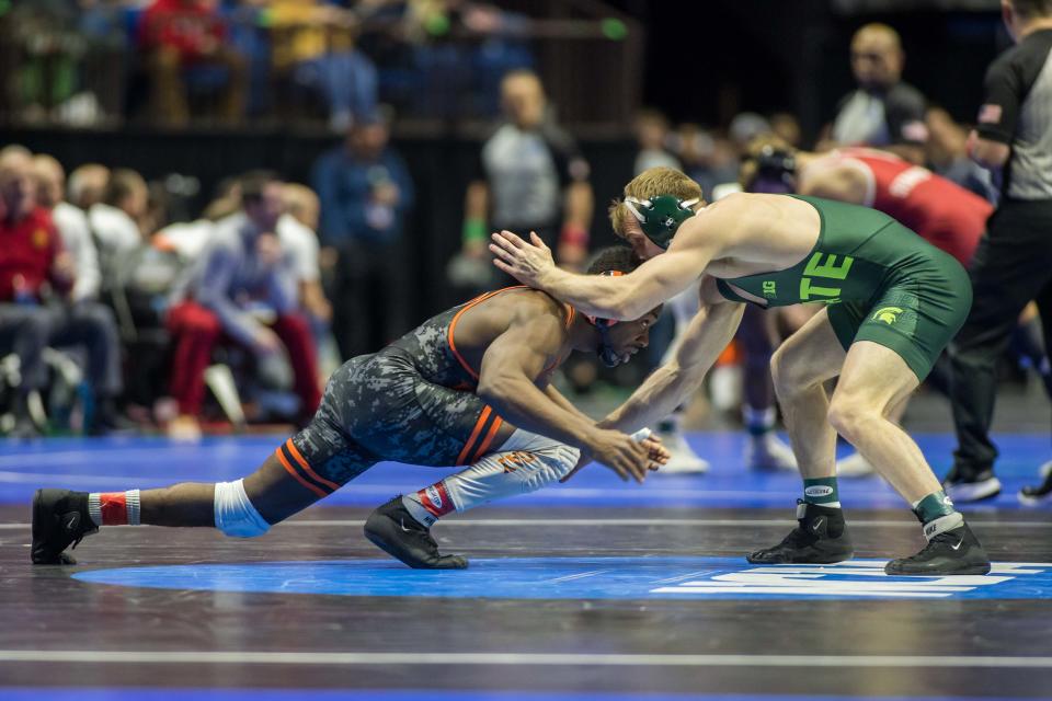 Mar 17, 2023; Tulsa, OK, USA;  Princeton wrestler Quincy Monday (left) wrestles Michigan State wrestler Caleb Fish in a 165 pound weight class quarterfinal during the NCAA Wrestling Championships at the BOK Center. Mandatory Credit: Brett Rojo-USA TODAY Sports